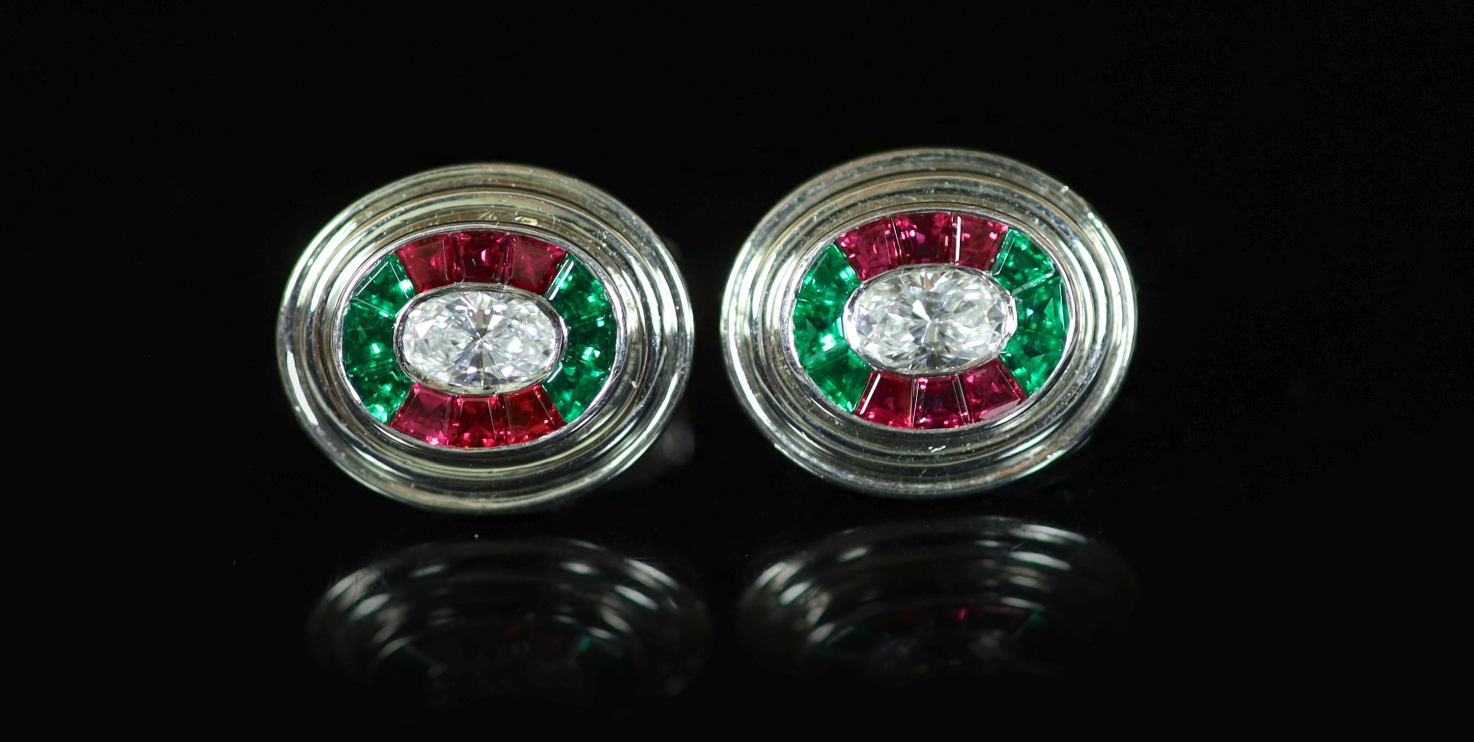A pair of modern Asprey 18ct gold and platinum, ruby, emerald and diamond oval cufflinks